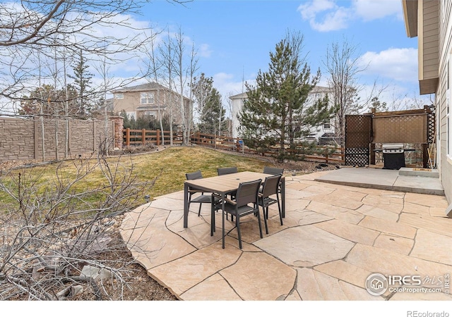 view of patio / terrace with fence, grilling area, and outdoor dining space