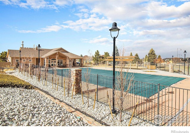 community pool featuring a patio area and fence