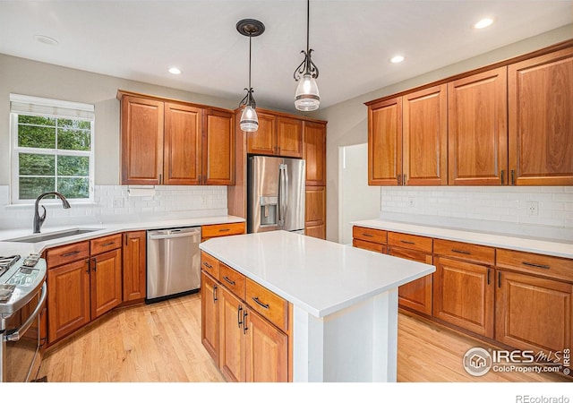 4910 Crimson Star Dr, Broomfield, CO 80023 - kitchen with stainless steel appliances, brown cabinetry, light wood-type flooring, and recessed lighting