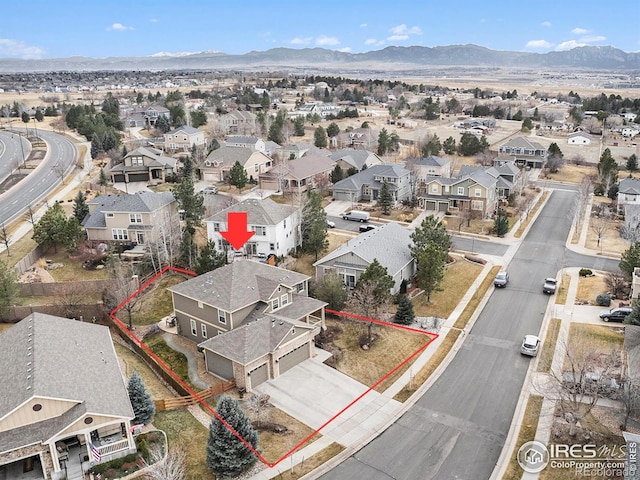 4910 Crimson Star Dr, Broomfield, CO 80023 - aerial perspective of suburban area with property parcel outlined and a mountain backdrop