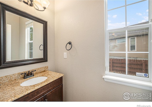4910 Crimson Star Dr, Broomfield, CO 80023 - bathroom featuring a textured wall and vanity