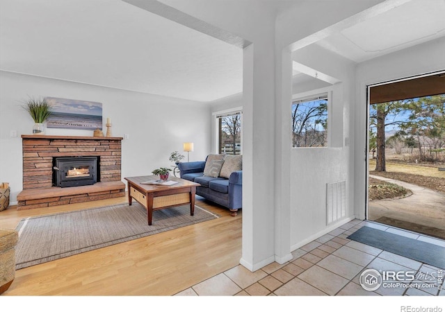 living room featuring visible vents, baseboards, and light tile patterned flooring