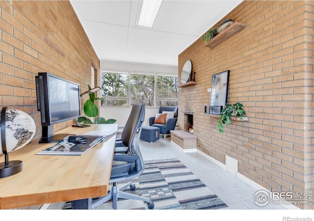 home office with brick wall