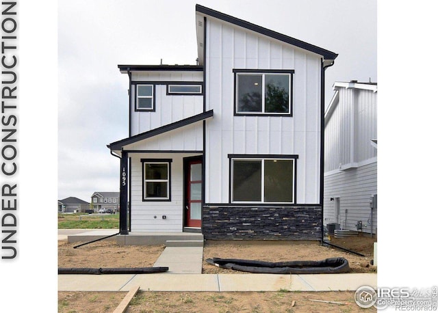 view of front of property with stone siding and board and batten siding