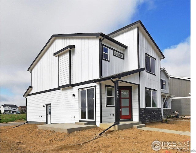 view of front of house featuring board and batten siding and a patio