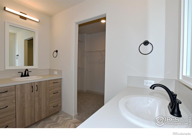 bathroom with vanity and a spacious closet