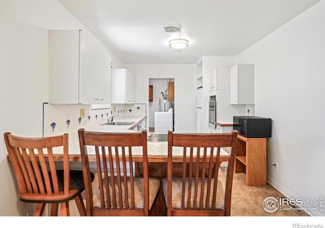 dining area featuring baseboards