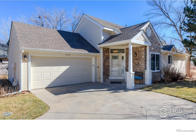 view of front of property with driveway, stone siding, roof with shingles, and an attached garage