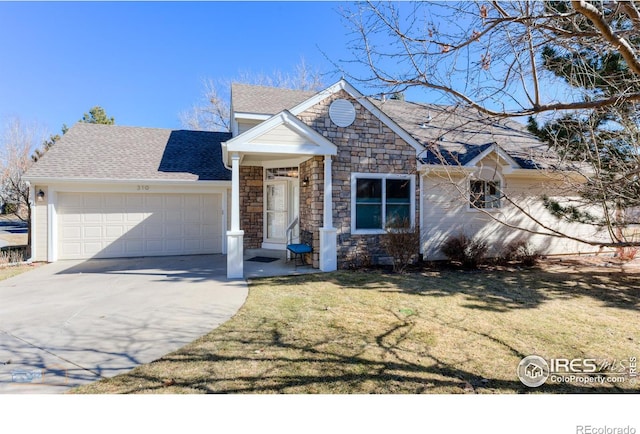 view of front of house featuring roof with shingles, concrete driveway, an attached garage, a front yard, and stone siding