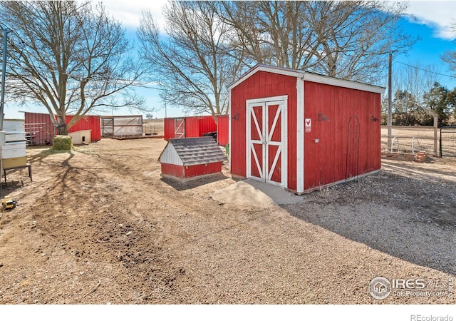 view of shed featuring fence