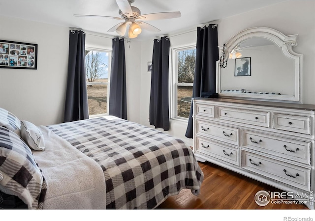 bedroom featuring dark wood-style floors and a ceiling fan