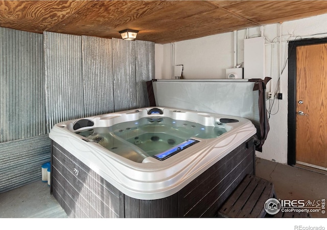 miscellaneous room with wooden ceiling, a jacuzzi, and concrete flooring