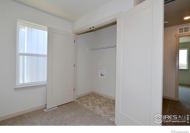 clothes washing area featuring carpet, hookup for a washing machine, visible vents, laundry area, and baseboards