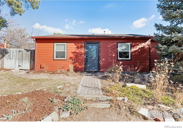 view of front of home featuring fence