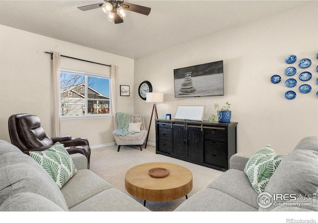 living room with carpet, ceiling fan, and baseboards