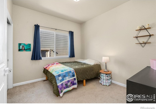 bedroom with carpet flooring and baseboards