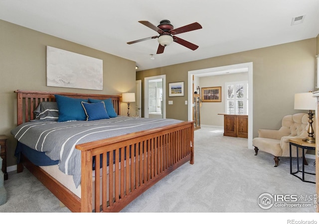 carpeted bedroom with visible vents and ceiling fan