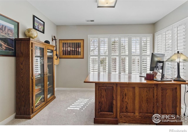 carpeted home office with visible vents and baseboards