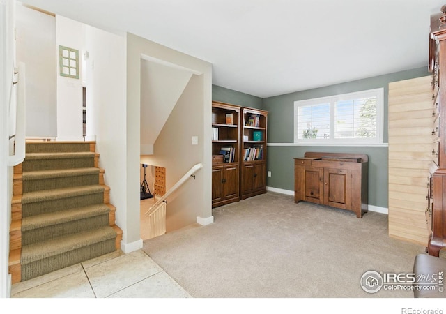 carpeted living room featuring baseboards