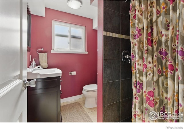 full bath featuring toilet, vanity, baseboards, a tile shower, and tile patterned floors