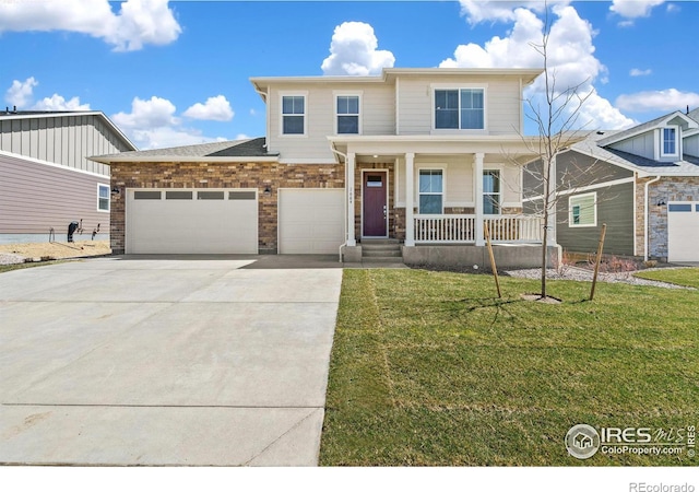 view of front facade with a garage, concrete driveway, a porch, and a front yard