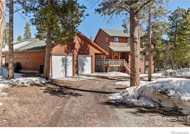 rustic home with driveway and a garage