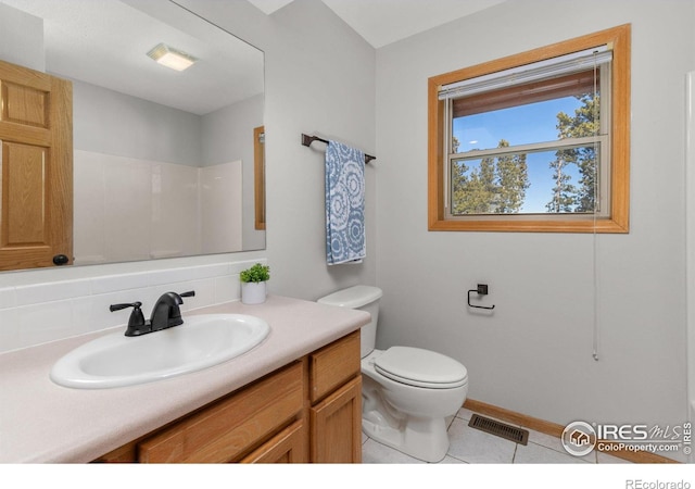 full bathroom featuring visible vents, toilet, vanity, tile patterned flooring, and baseboards