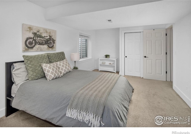 bedroom featuring carpet, a closet, visible vents, and baseboards