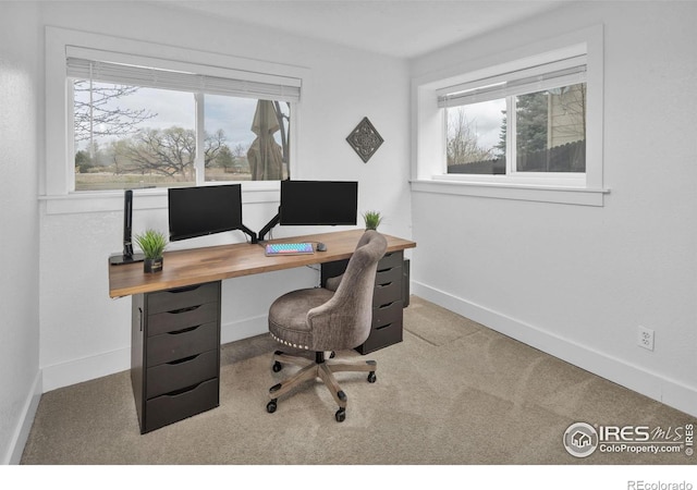 carpeted office featuring baseboards and a healthy amount of sunlight