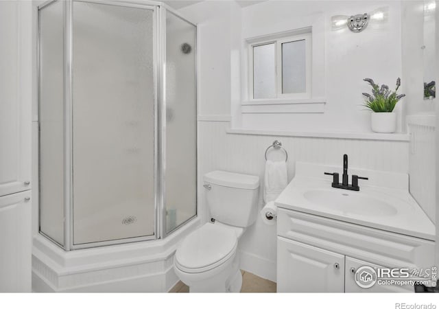 full bath with toilet, a shower stall, and vanity