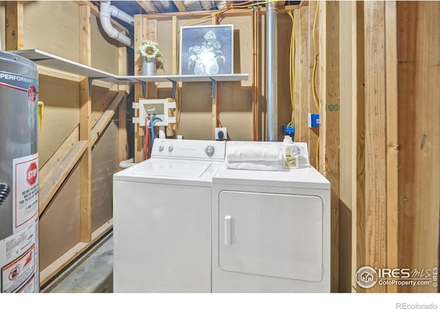 clothes washing area with laundry area, separate washer and dryer, and gas water heater