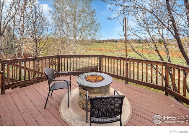 wooden deck featuring an outdoor fire pit