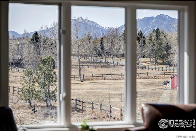 doorway featuring a rural view and a mountain view