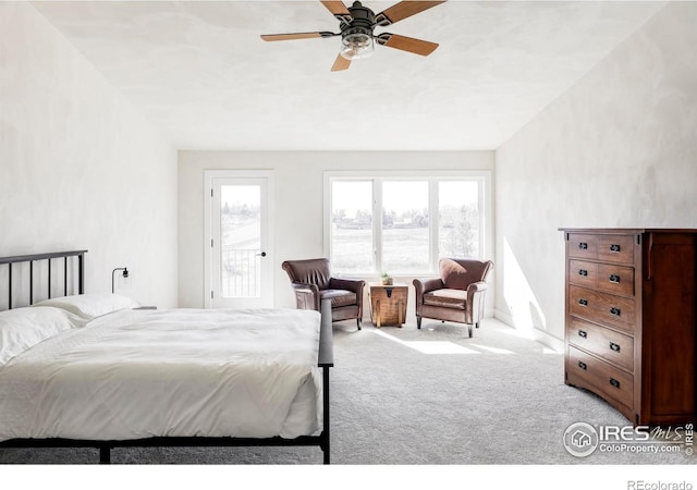 carpeted bedroom with a ceiling fan, multiple windows, vaulted ceiling, and baseboards