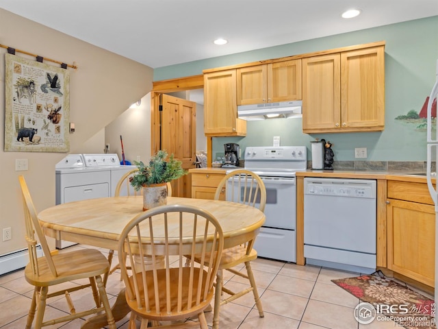 kitchen featuring white appliances, under cabinet range hood, washer and clothes dryer, and light brown cabinetry