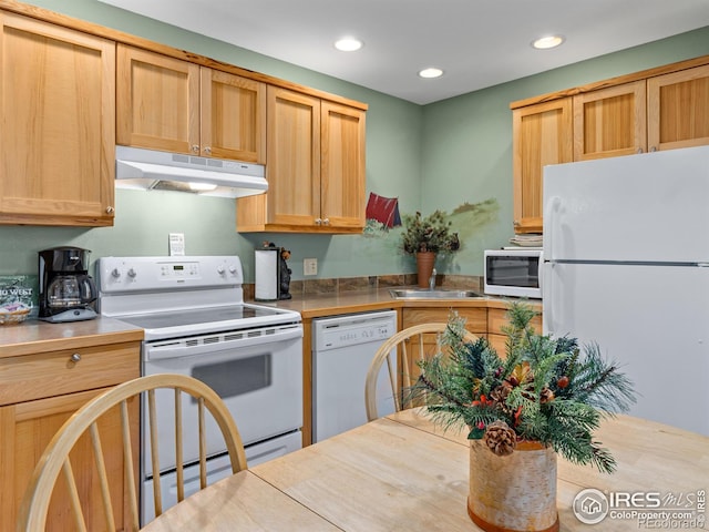 kitchen featuring recessed lighting, white appliances, a sink, and under cabinet range hood