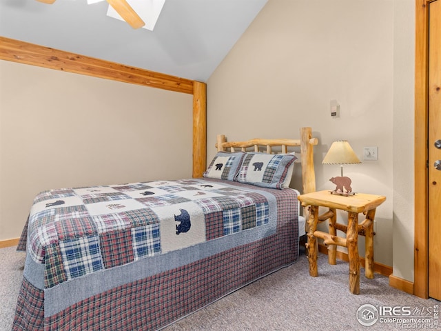 carpeted bedroom featuring ceiling fan, vaulted ceiling with skylight, and baseboards