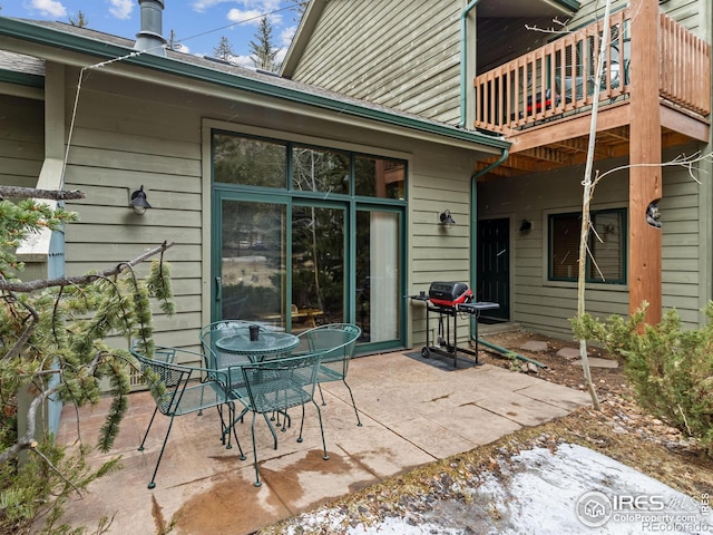 view of patio with outdoor dining space and a grill