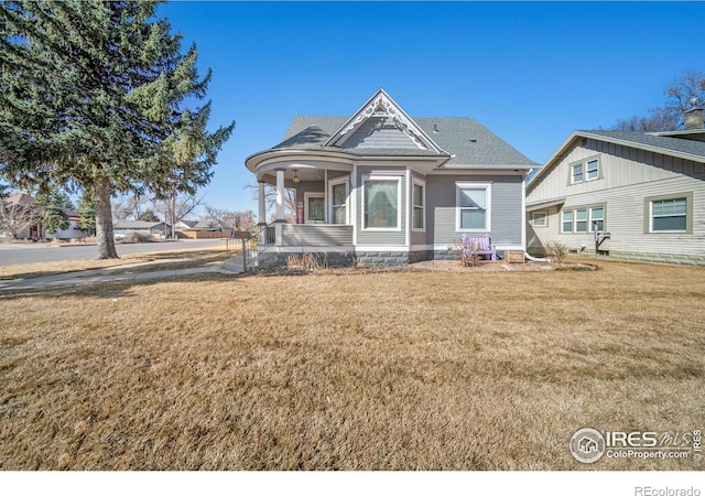 victorian-style house with roof with shingles and a front lawn