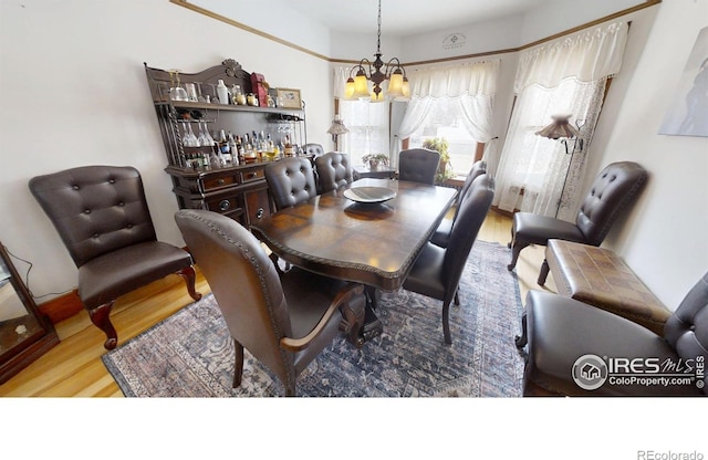 dining room featuring a notable chandelier and wood finished floors