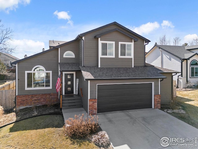 view of front of house featuring driveway, a garage, roof with shingles, fence, and brick siding