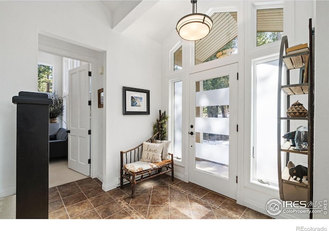 doorway to outside featuring lofted ceiling and baseboards