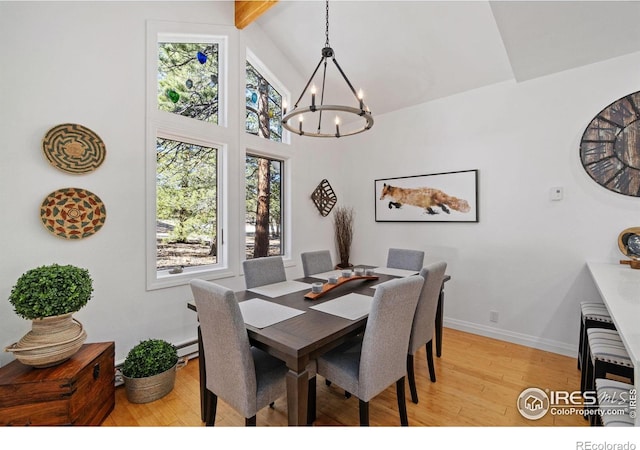 dining space with a chandelier, light wood-style flooring, high vaulted ceiling, beamed ceiling, and baseboards