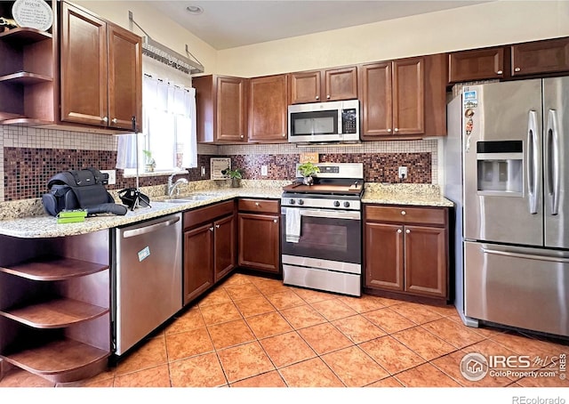 kitchen with light tile patterned floors, a sink, stainless steel appliances, open shelves, and backsplash