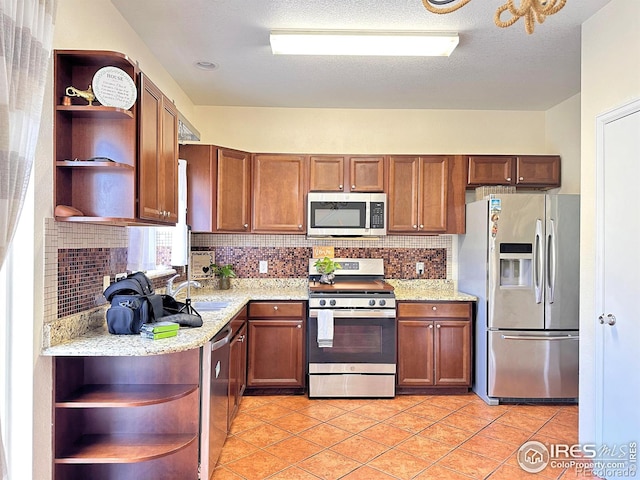 kitchen with light tile patterned floors, appliances with stainless steel finishes, open shelves, and decorative backsplash