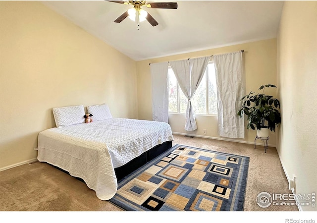 carpeted bedroom featuring vaulted ceiling, ceiling fan, and baseboards