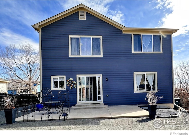 rear view of house featuring entry steps and a patio area