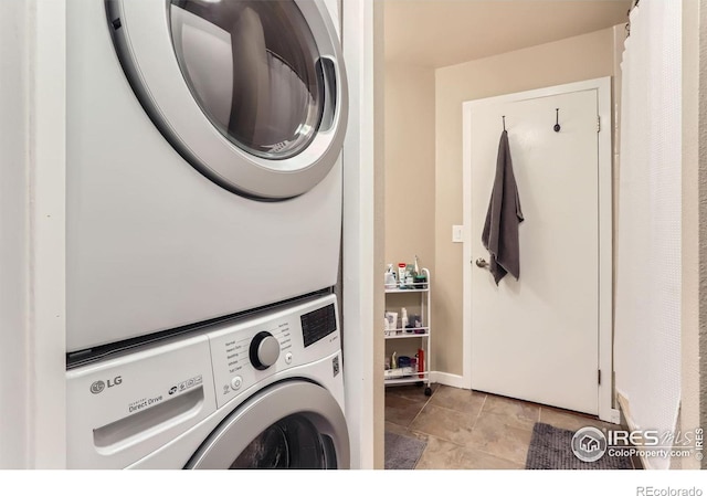 washroom with stacked washer / drying machine and laundry area