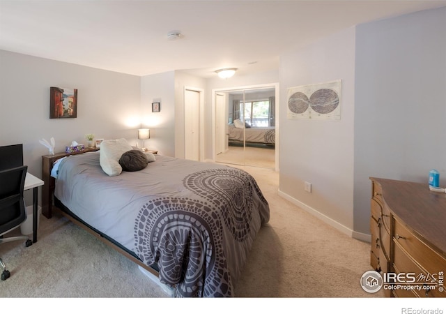 bedroom featuring light carpet and baseboards