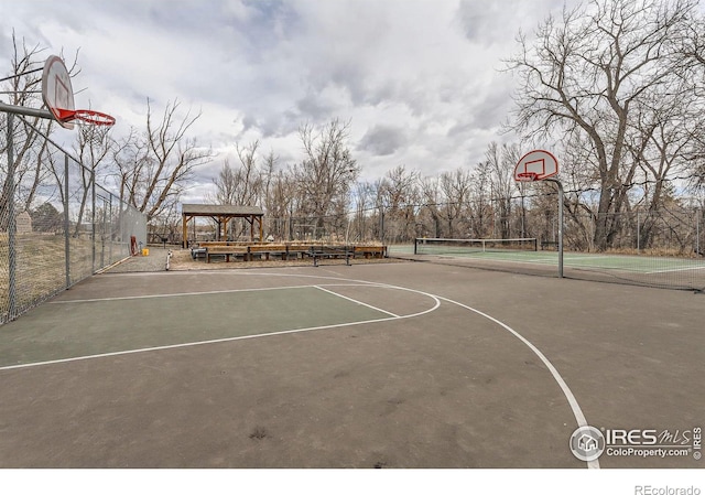 view of basketball court featuring community basketball court and fence